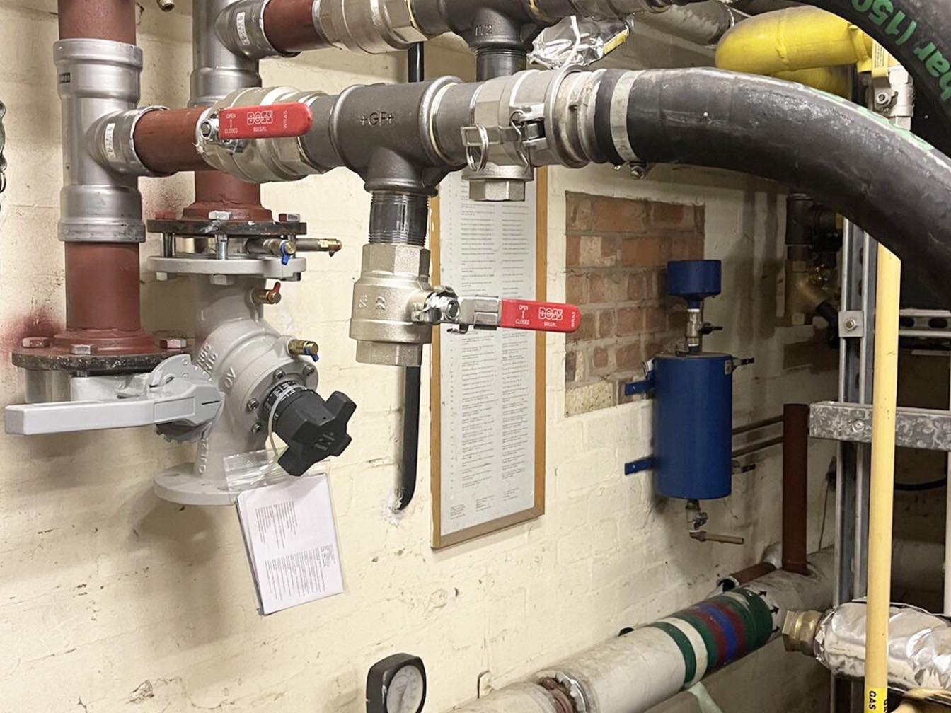 Temporary boiler hoses connected into a building’s pipework through a header