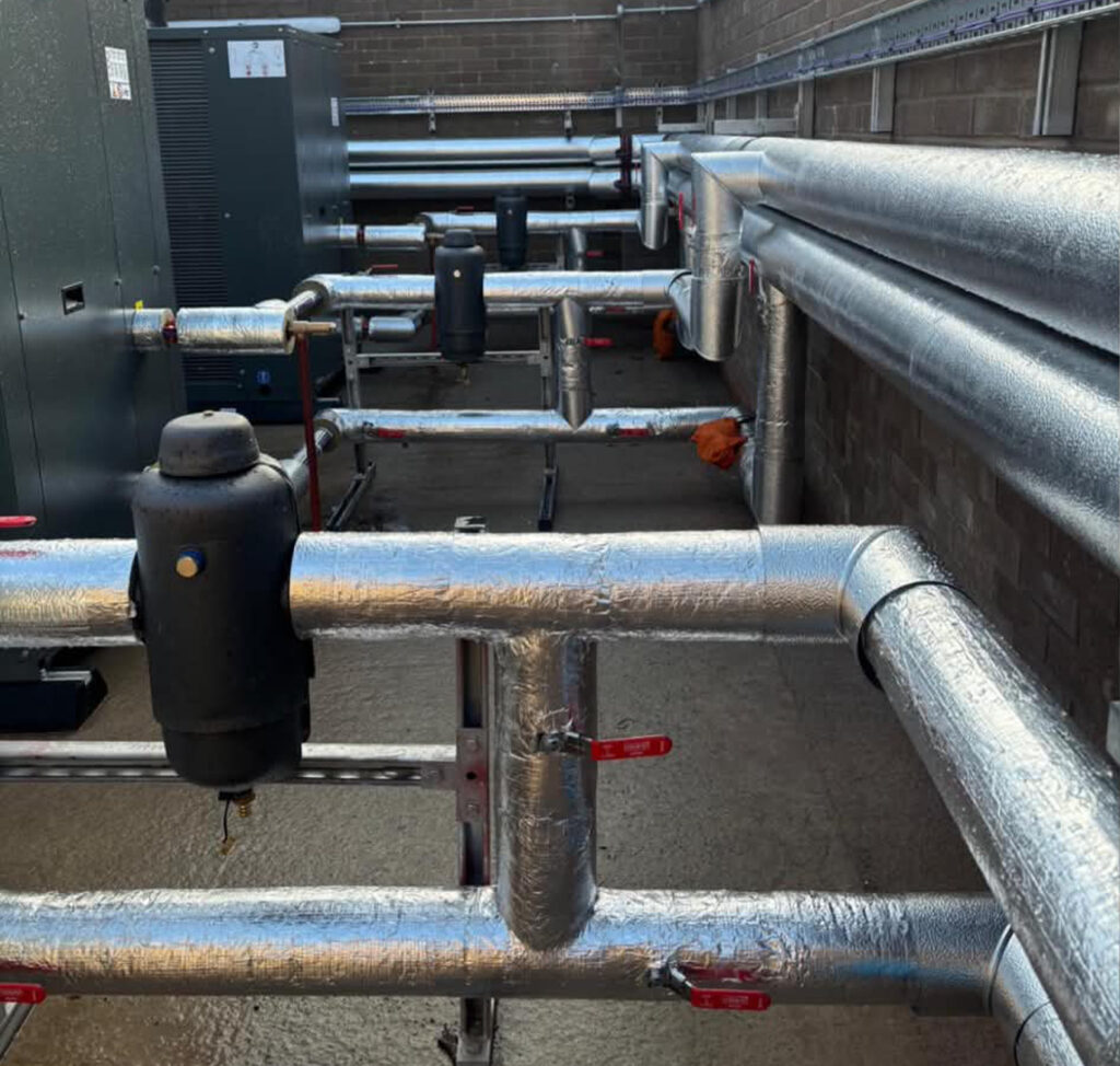 Home 3 Insulated external pipework runs serving the new air source heat pump system at Blackley Crematorium